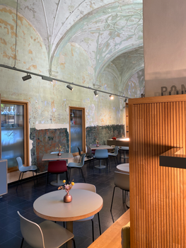 Cozy café interior with rustic charm and modern seating in Mechelen, Belgium.
