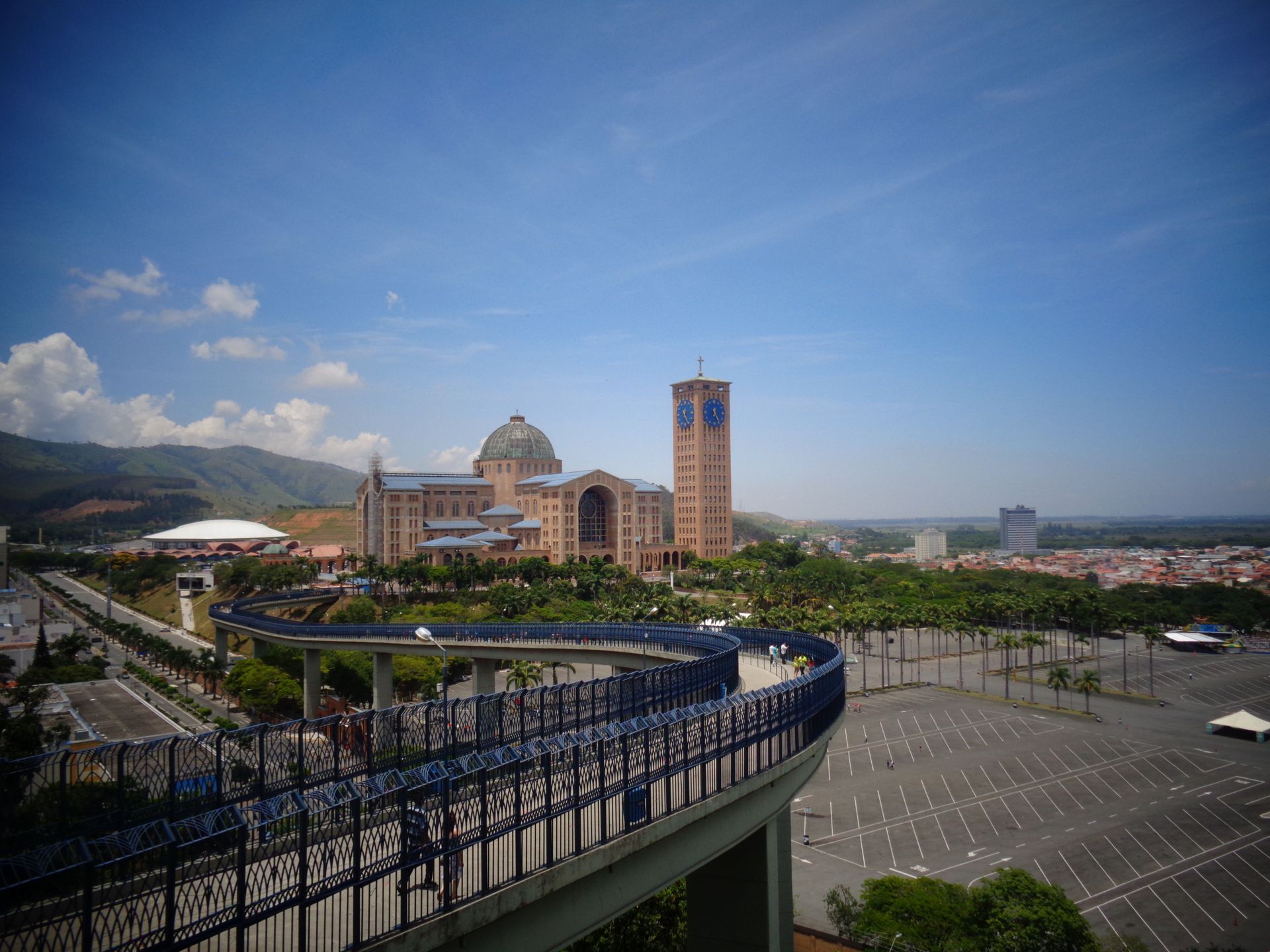 Stunning view of the Basilica of the National Shrine in Aparecida, Brazil, featuring the iconic clock tower and overpass.