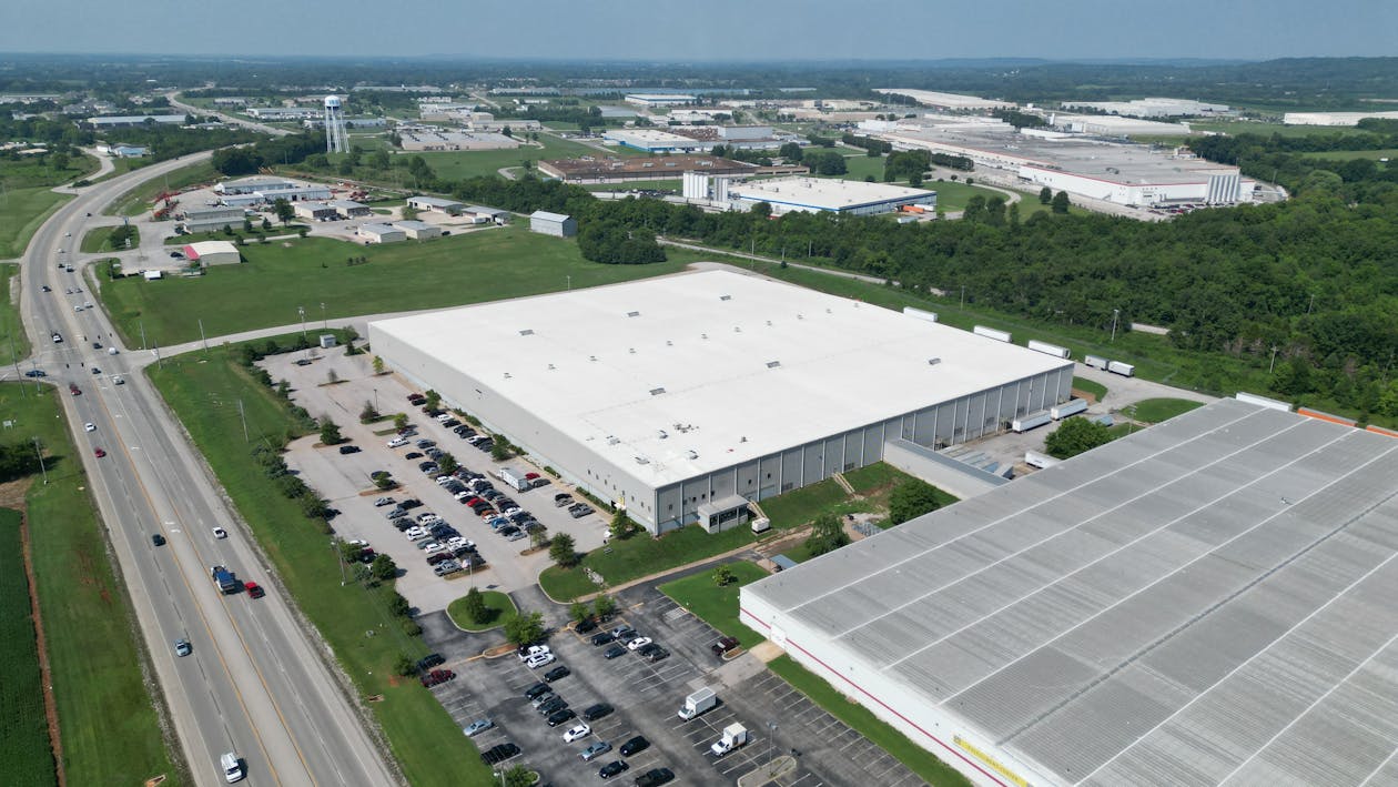 Aerial View of Buildings and Parking Lot with Cars