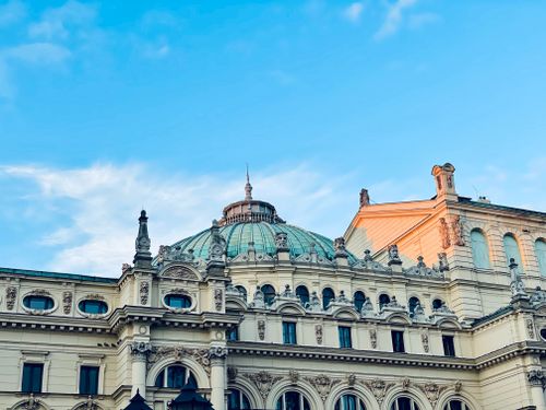 Free Classic architectural dome of Kraków's historic buildings captured against a clear blue sky. Stock Photo