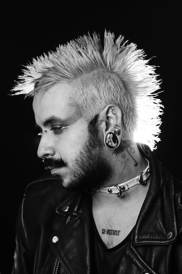 Side View Of Punk Man With Mohawk On Black Background