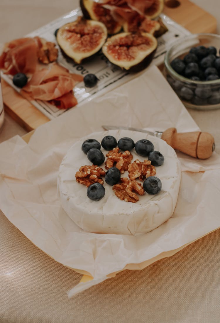 Brie, Fruit And Meat On Table