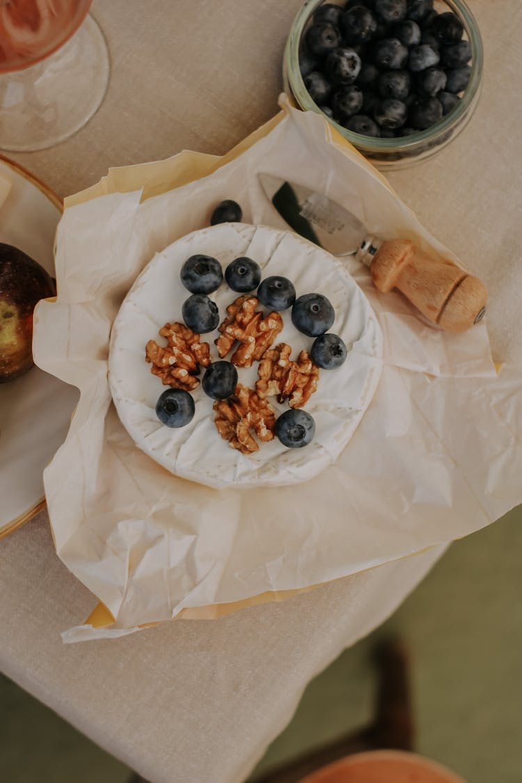 Brie With Berries And Nuts On Table