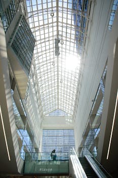 Sunlit glass atrium in a modern building in the heart of Montréal.