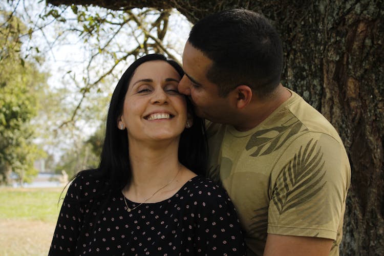 Man Kissing Woman On Cheek