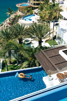 Relaxing poolside in a luxurious resort in Cabo San Lucas with ocean views.