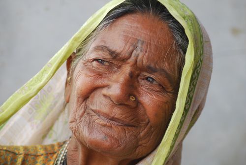 Free Close-up portrait of an elderly Indian woman wearing a headscarf, capturing wisdom and tradition. Stock Photo