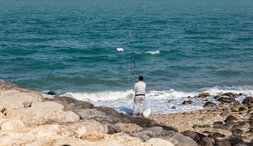 A Man Fishing on a Shore