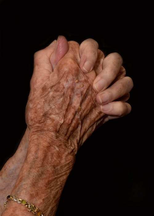 Close-Up Shot of an Elderly Person Praying