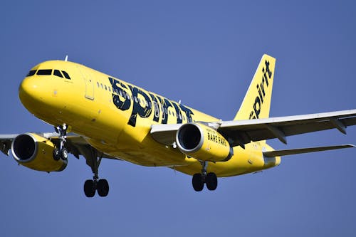 Free A Yellow Airplane Flying in the Sky Stock Photo