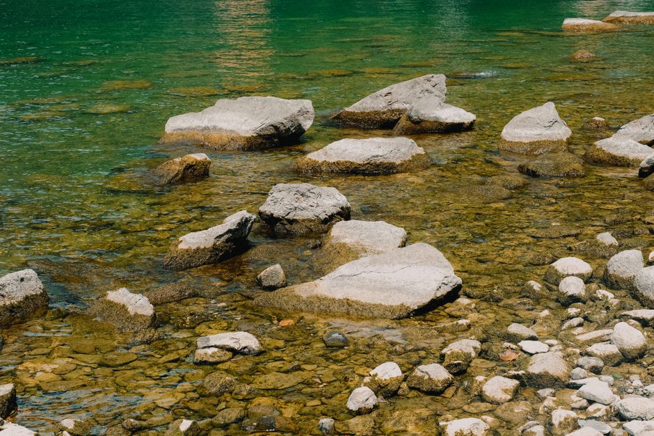 Scenic view of rocks in a clear green river showing natural beauty and tranquility.