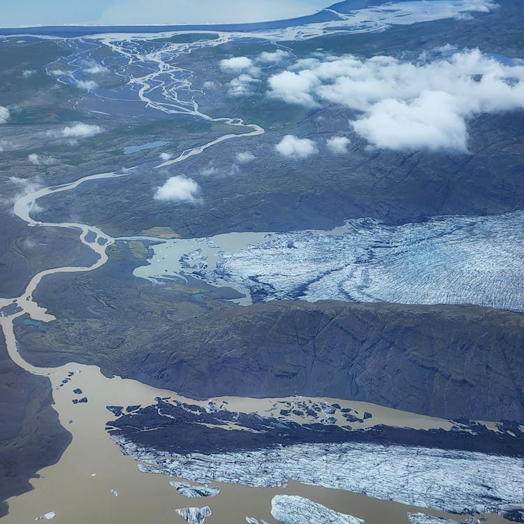 Birds Eye View Of A Mountain Glacier Melting Into A River 