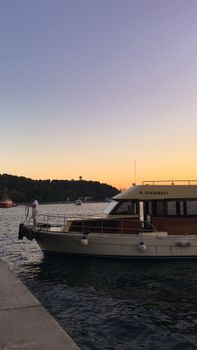 A picturesque yacht docked during sunset, capturing serenity and maritime elegance.