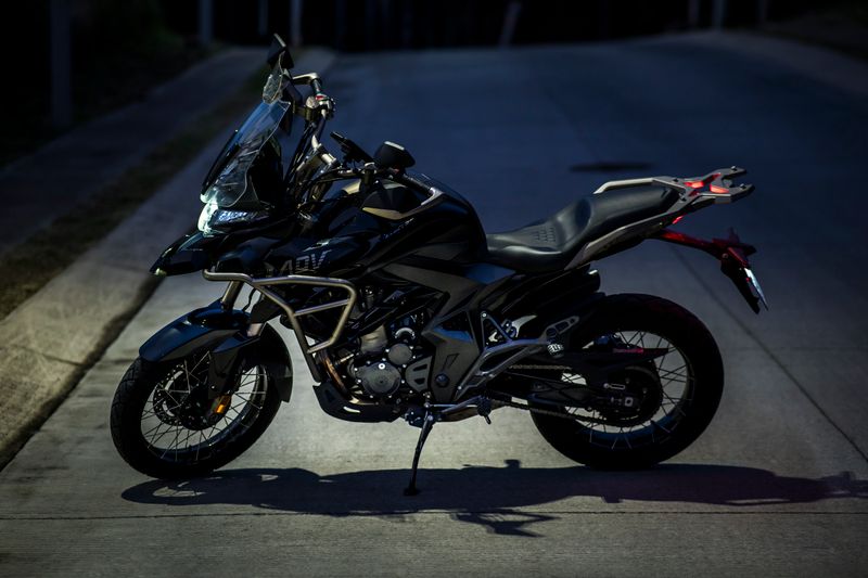 High-performance adventure motorcycle parked on a dimly lit urban street