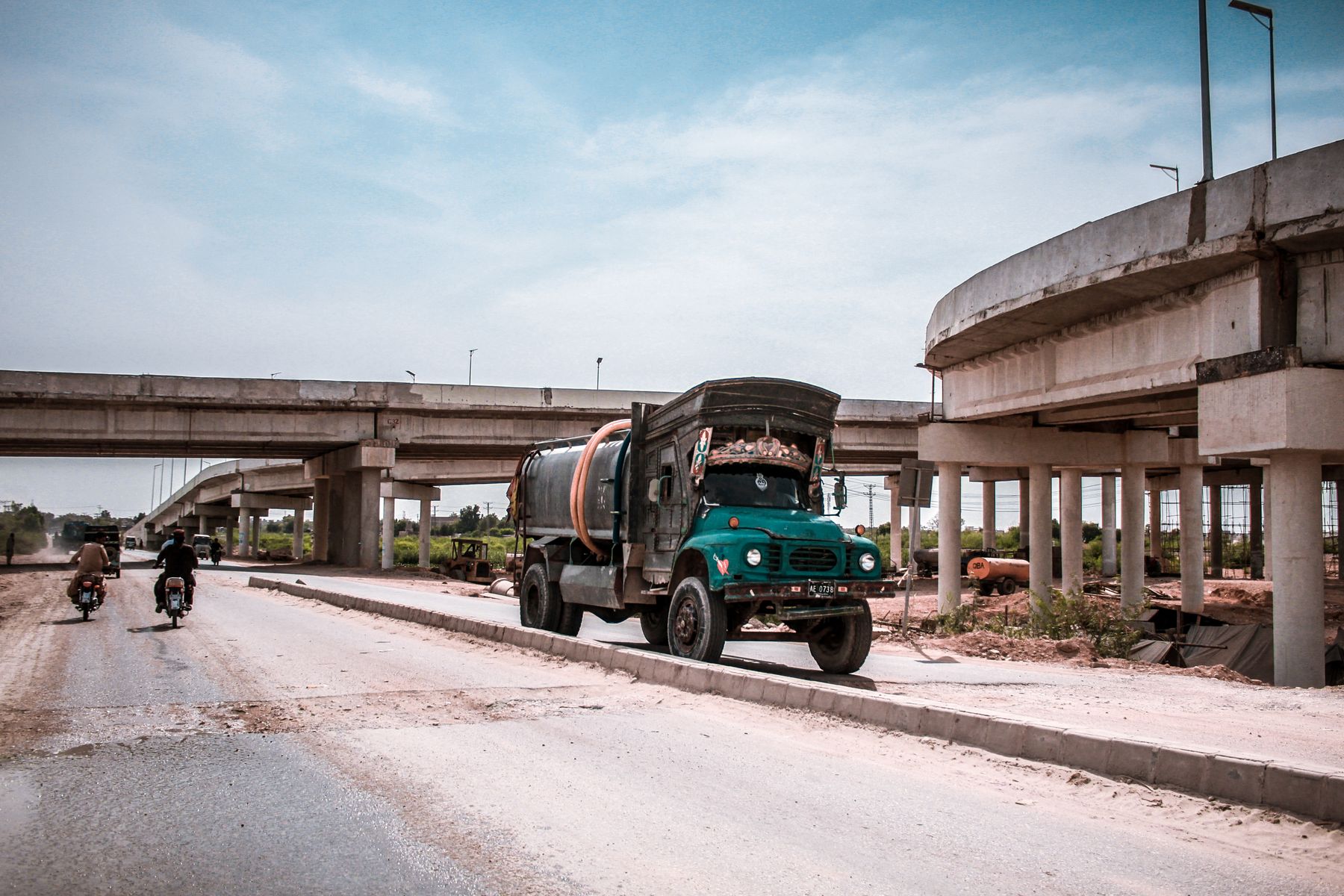Tanker truck and vehicles on a highway in Kotri, Sindh, Pakistan. Urban transportation system.