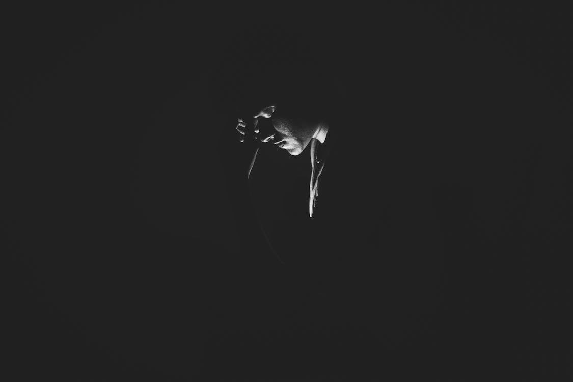 Monochrome Photography of Person On Dark Room