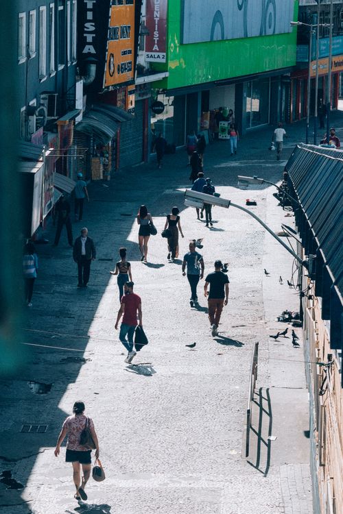 Free Aerial view of a bustling city street with diverse people walking in daylight. Stock Photo