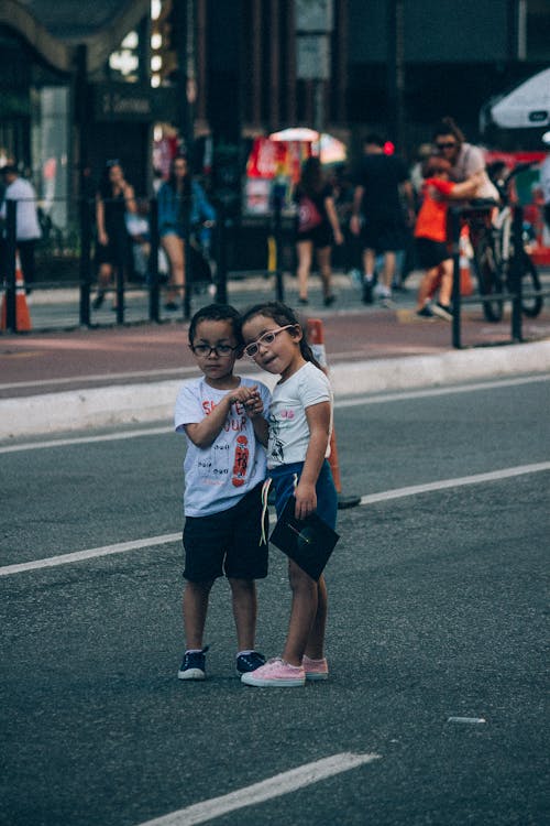 Little Boy and Girl Standing on the Street