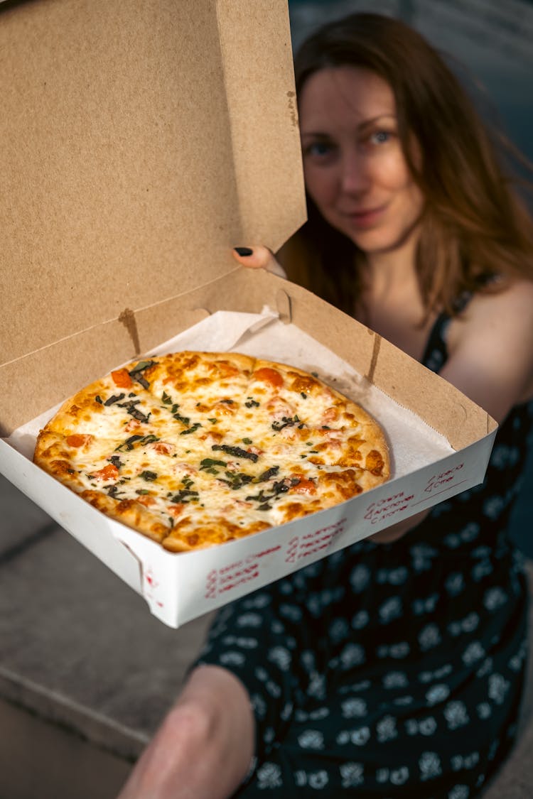 Woman Holding Pizza In Box 