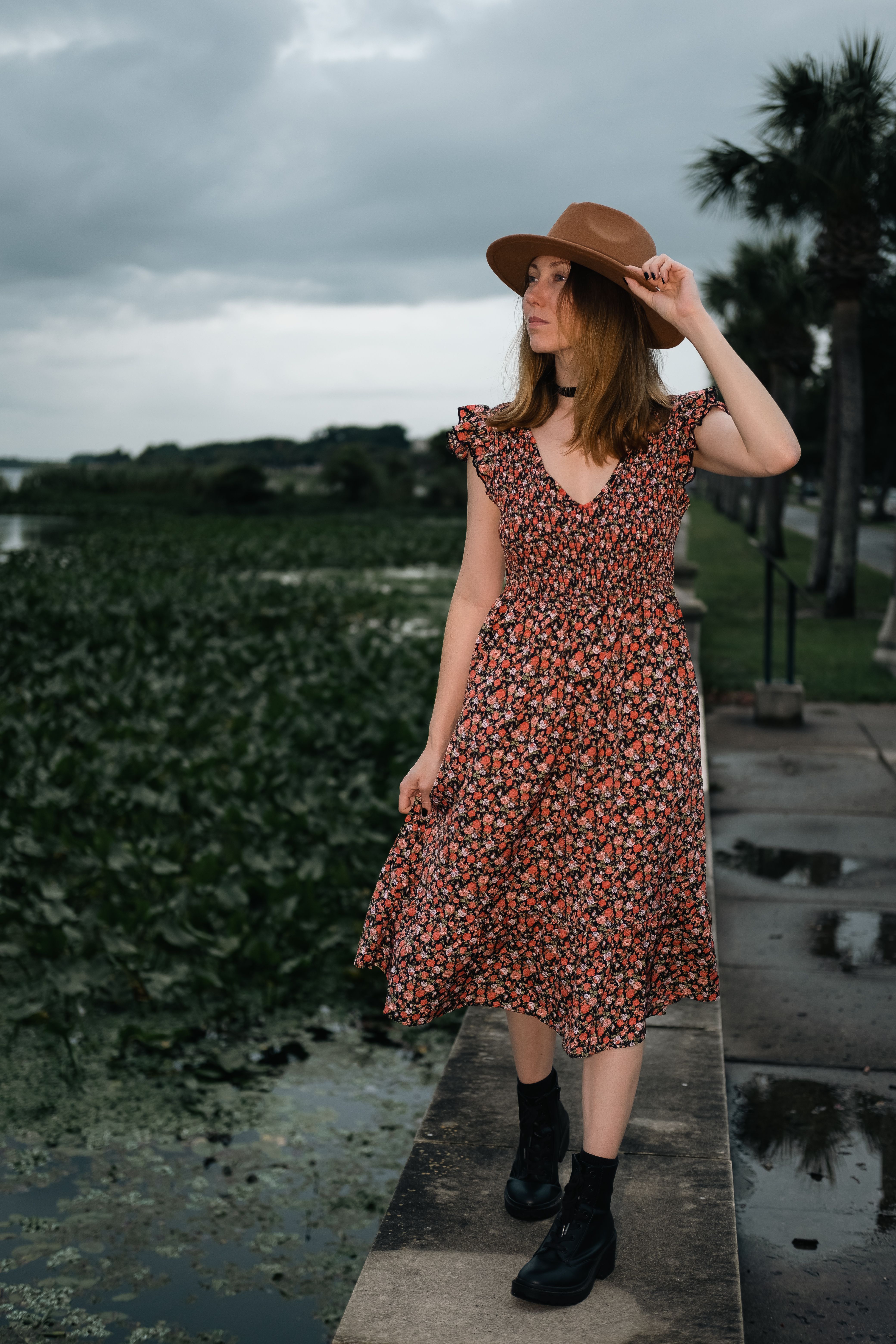 Woman in Printed Dress Standing Beside a Body of Water · Free Stock Photo