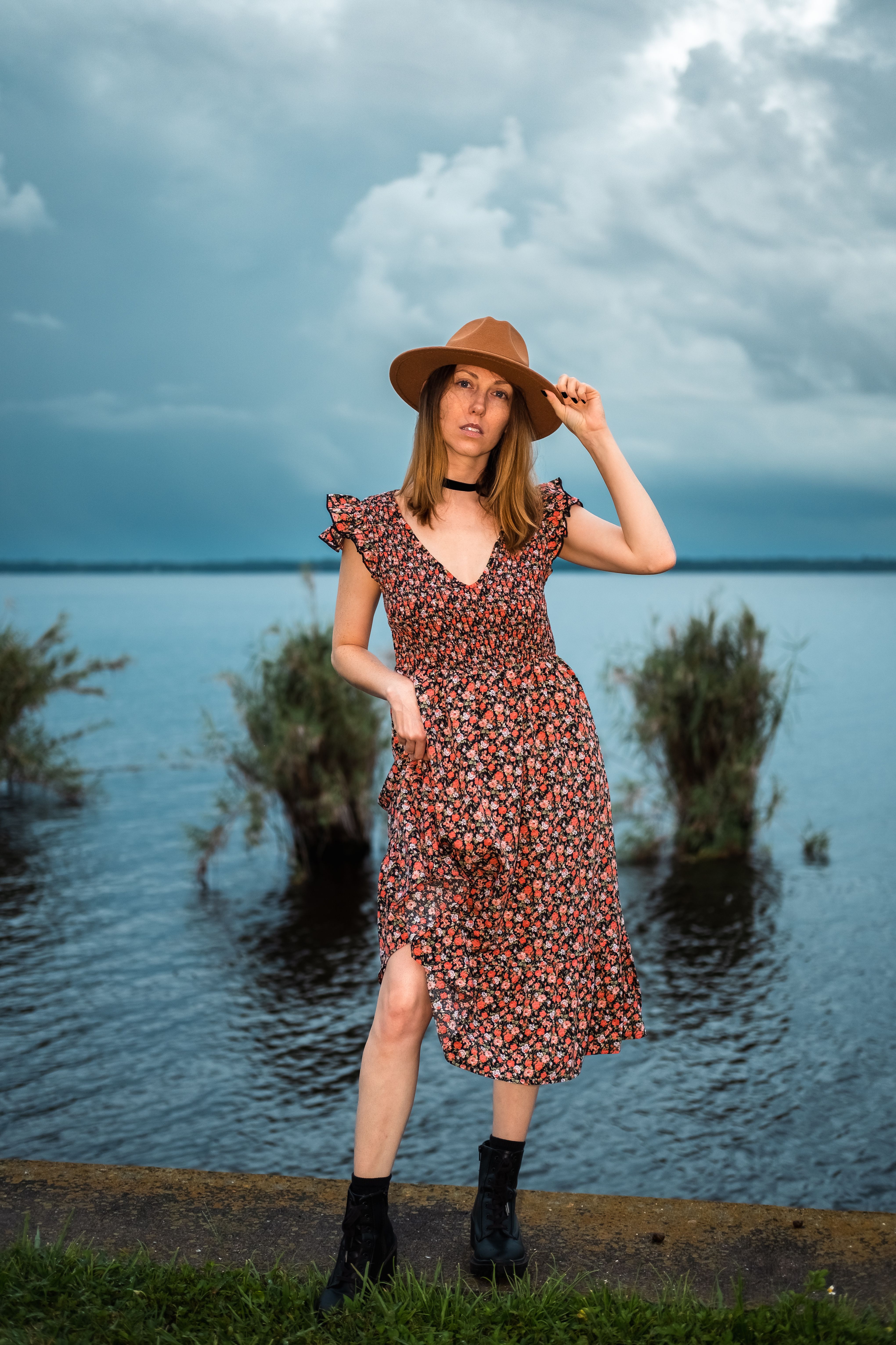 Woman in Printed Dress Standing Beside a Body of Water · Free Stock Photo