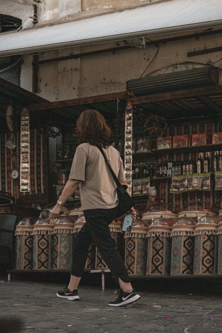 Candid Picture Of A Woman Walking On The Sidewalk 