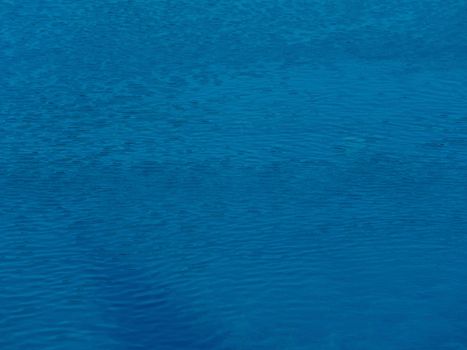 A tranquil view of calm blue ocean water with gentle ripples and a serene atmosphere.