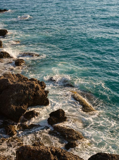 Free Stunning view of ocean waves crashing against rocky shore, capturing nature's power. Stock Photo