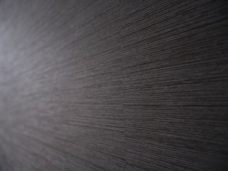 Close-up of textured gray wallpaper featuring subtle horizontal lines creating a modern pattern.