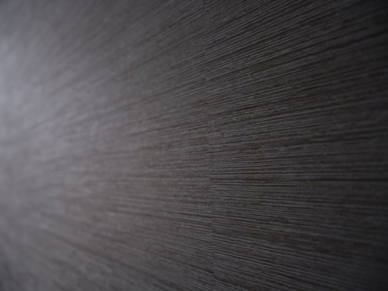 close up of textured gray wallpaper featuring subtle horizontal lines