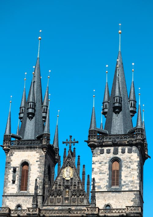 Free Majestic Gothic spires of the Church of Our Lady before Týn in Prague against a vibrant blue sky. Stock Photo