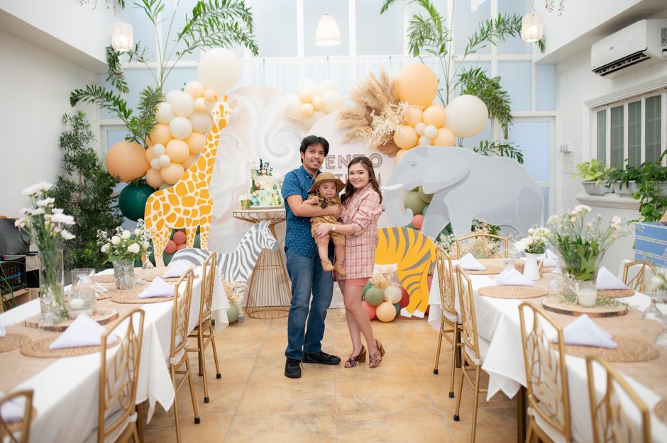 A joyful family celebrating in a safari-themed setting with animal decorations.