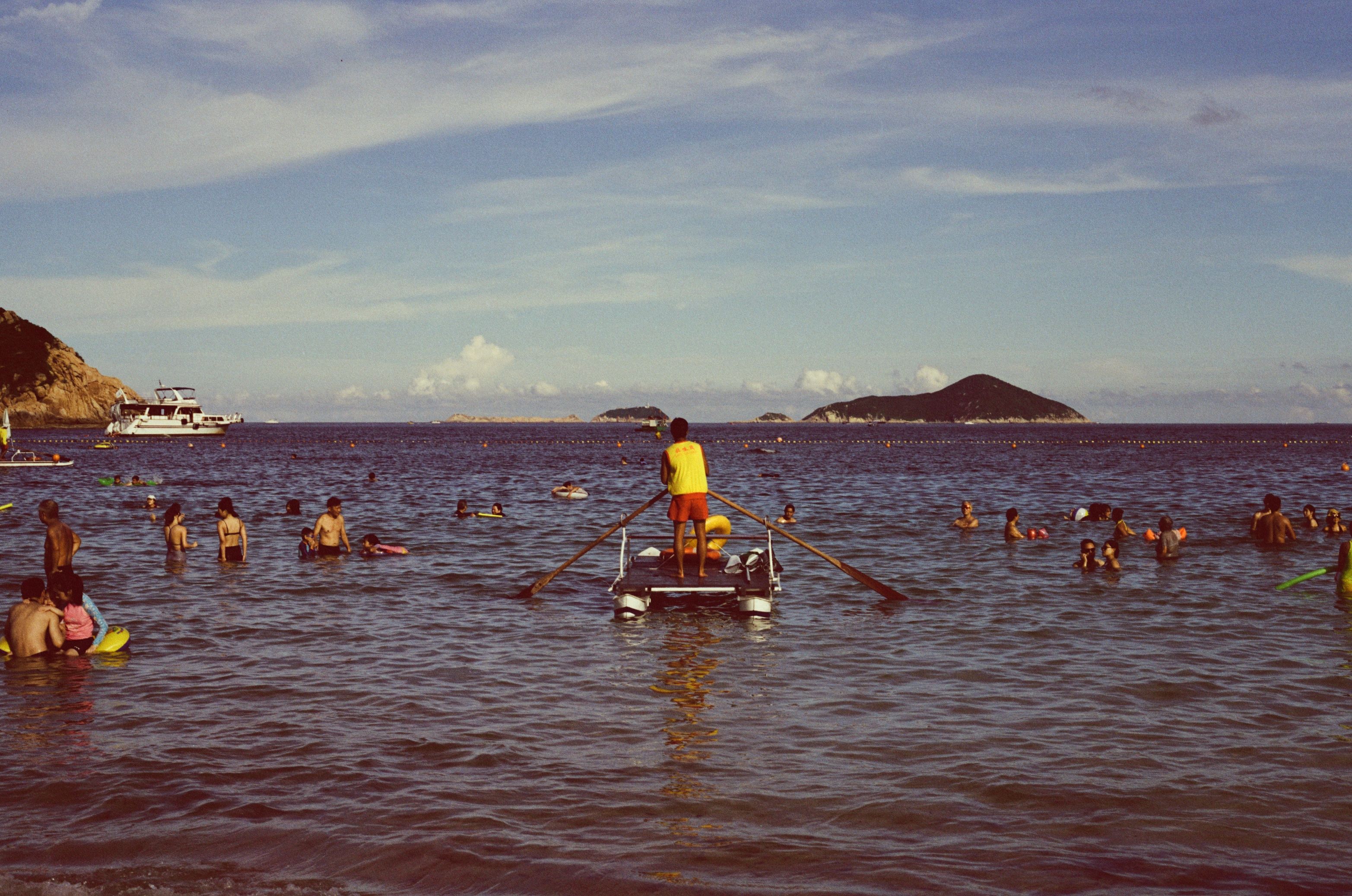 A Lifeguard Paddling a Raft · Free Stock Photo