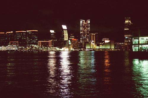 Free Captivating view of the Hong Kong cityscape reflecting over the harbor at night. Stock Photo