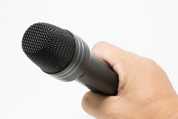 Close-Up Shot Of A Hand Holding A Microphone 