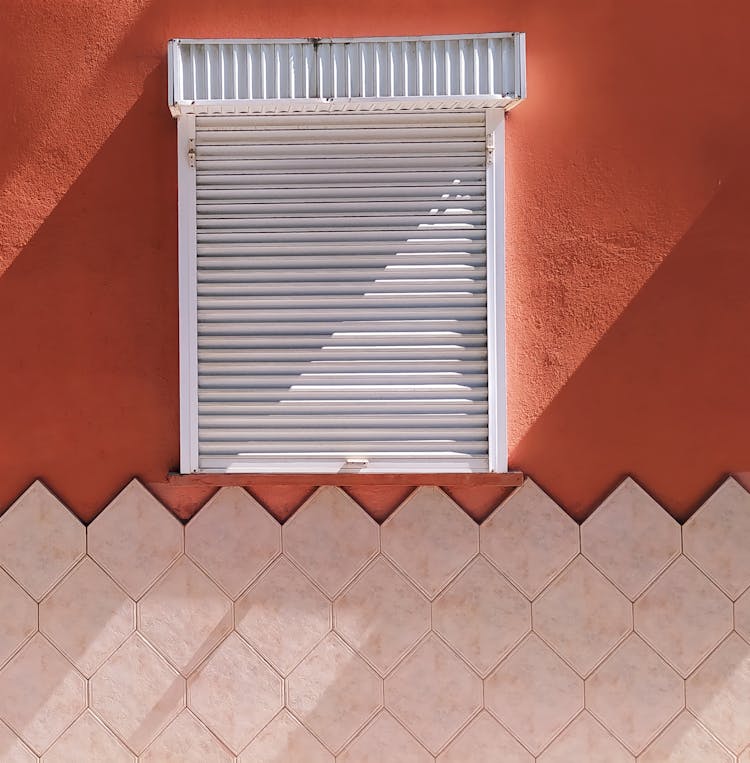 White Shutter On Red Wall