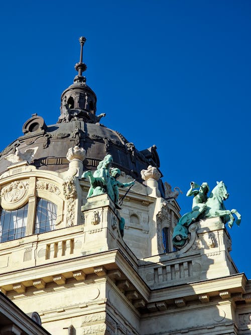 Concrete Building with Dome and Statues Under Blue Sky