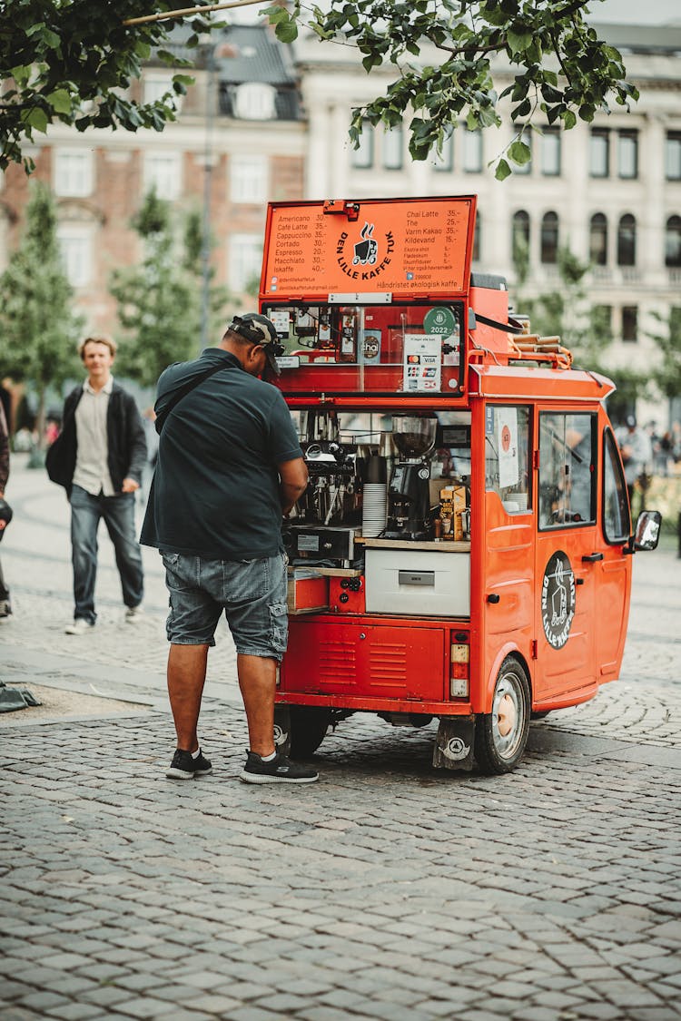 A Man Selling Coffee On A Food Truck