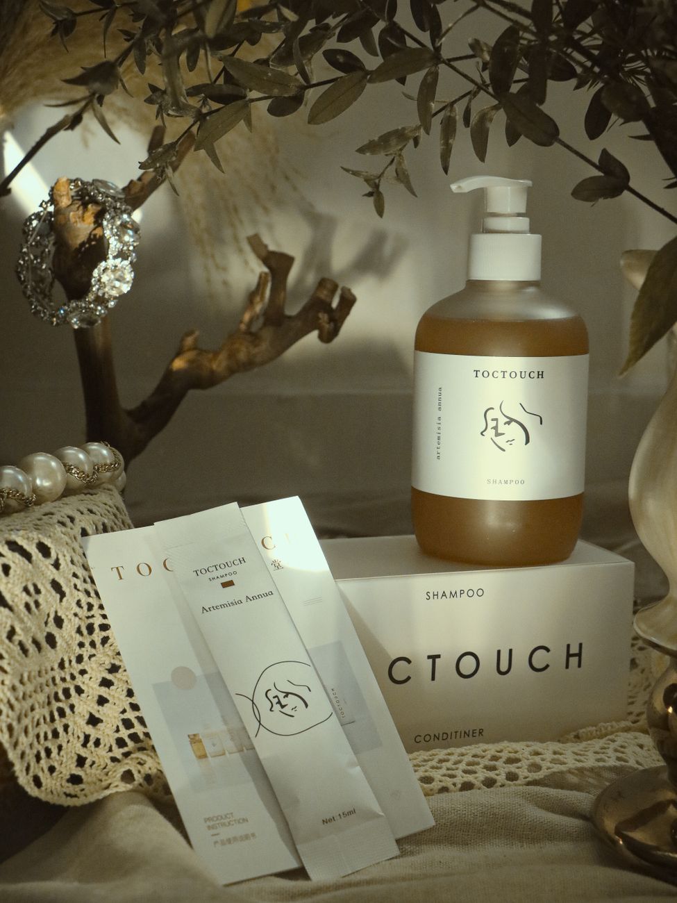 Elegant still life of luxurious toiletry products with nature elements.