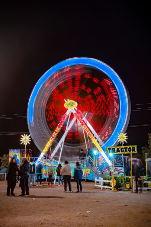 Free A stunning long exposure of a colorful Ferris wheel at night, capturing motion. Stock Photo