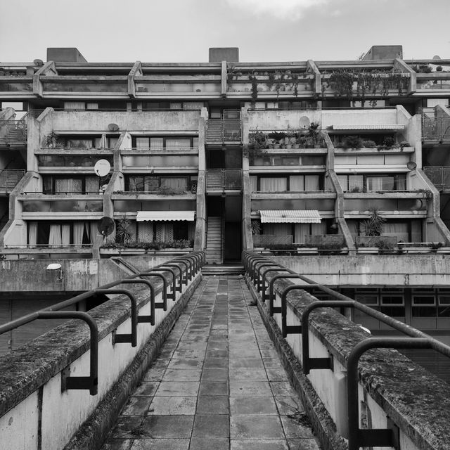 Black and white brutalist housing terrace — photo by Lee Paddy O'Sullivan on Pexels