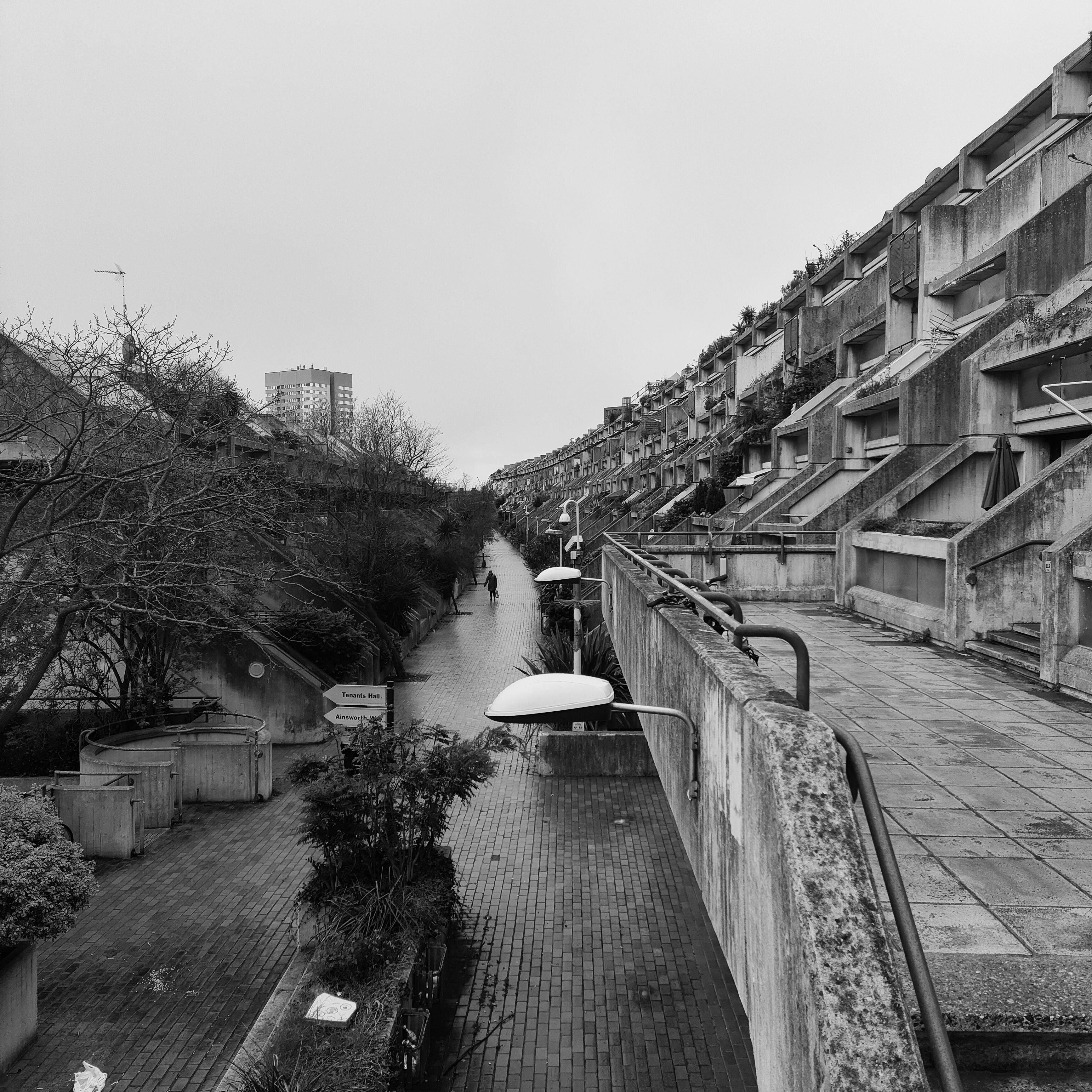 A Grayscale Photo of a Bridge In between Body of Water