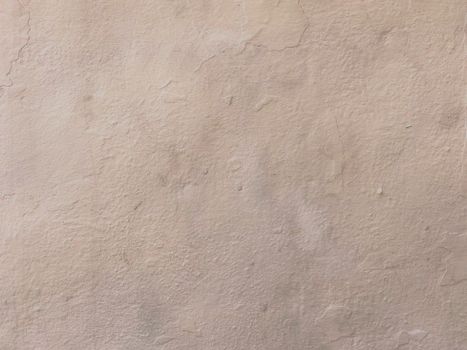 Close-up of a beige textured plaster wall surface, ideal for backgrounds.