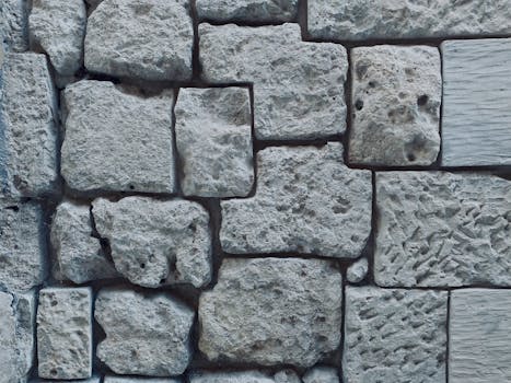 Close-up of a textured stone wall showcasing various shapes and a rough surface.