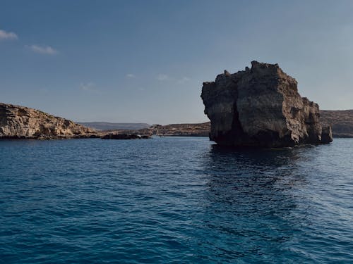 Rock Formation Surrounded on Body of Water