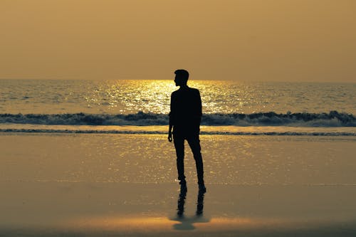 Silhouette of Man Standing on a Beach