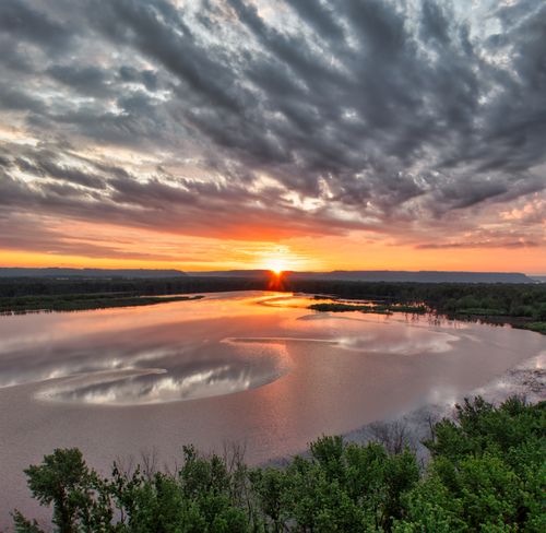 Free A stunning sunset view over a calm lake in Red Wing, Minnesota with dramatic clouds. Stock Photo