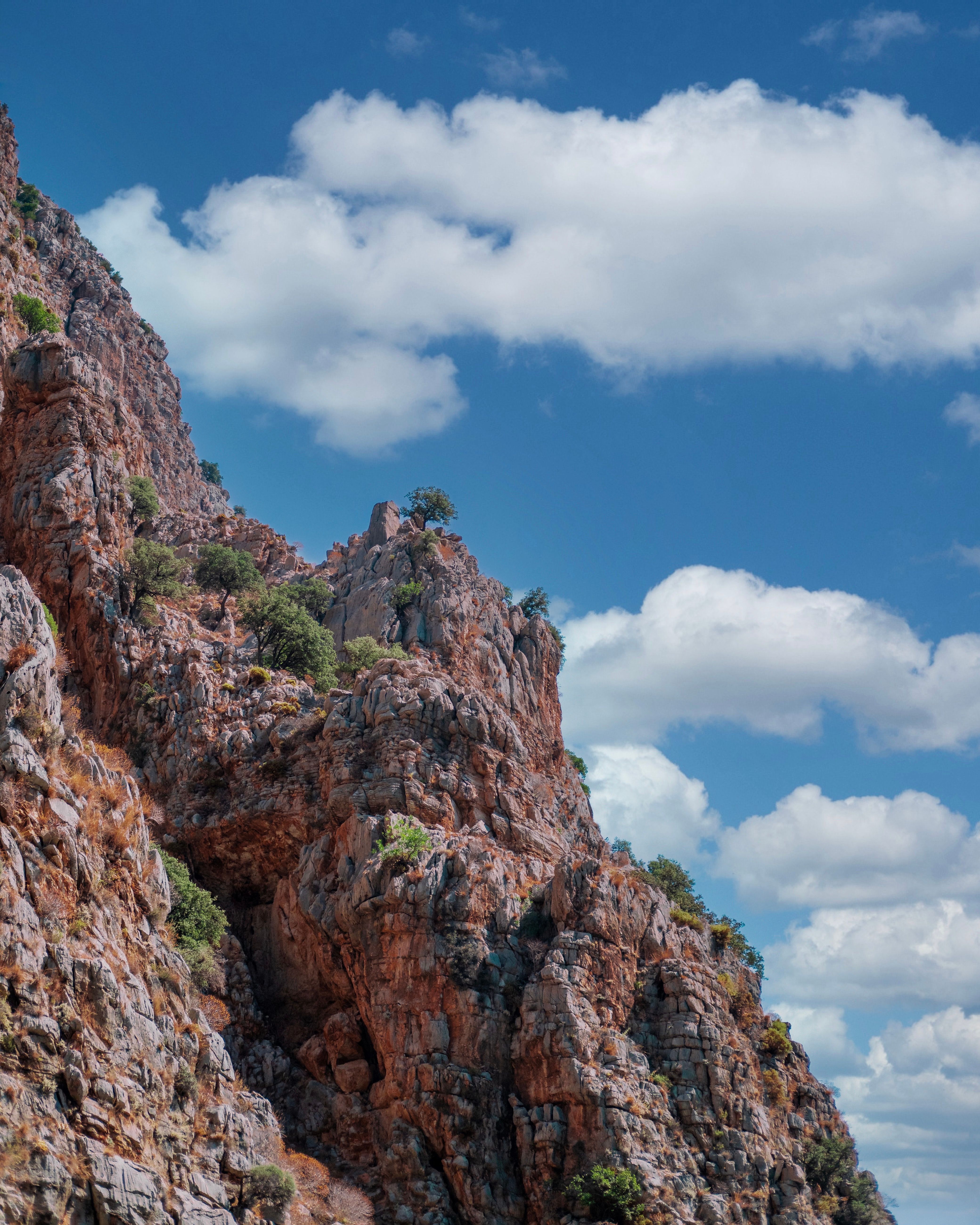 A Rocky Mountain under a Cloudy Blue Sky · Free Stock Photo