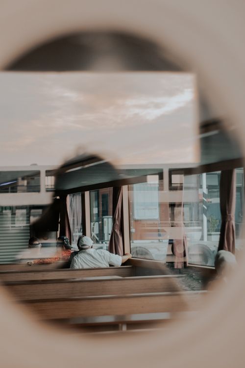 Free Artistic reflection of a seated passenger through a ferry window in Istanbul, Türkiye. Stock Photo