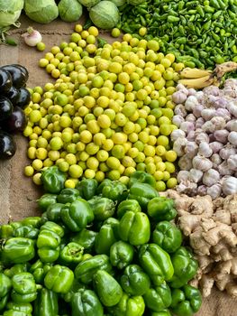 Colorful mix of fresh vegetables and fruits displayed at an outdoor market, perfect for a healthy diet.